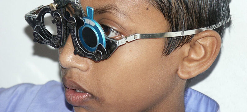 An eye examination for a primary school child in Bangladesh